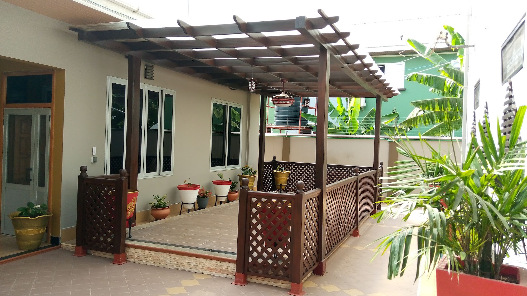 Timber pergola over a patio with decorative wood balustrades
