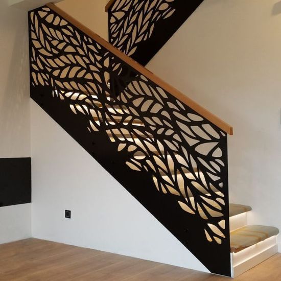 Decorative cut-pattern metal railing on an indoor staircase