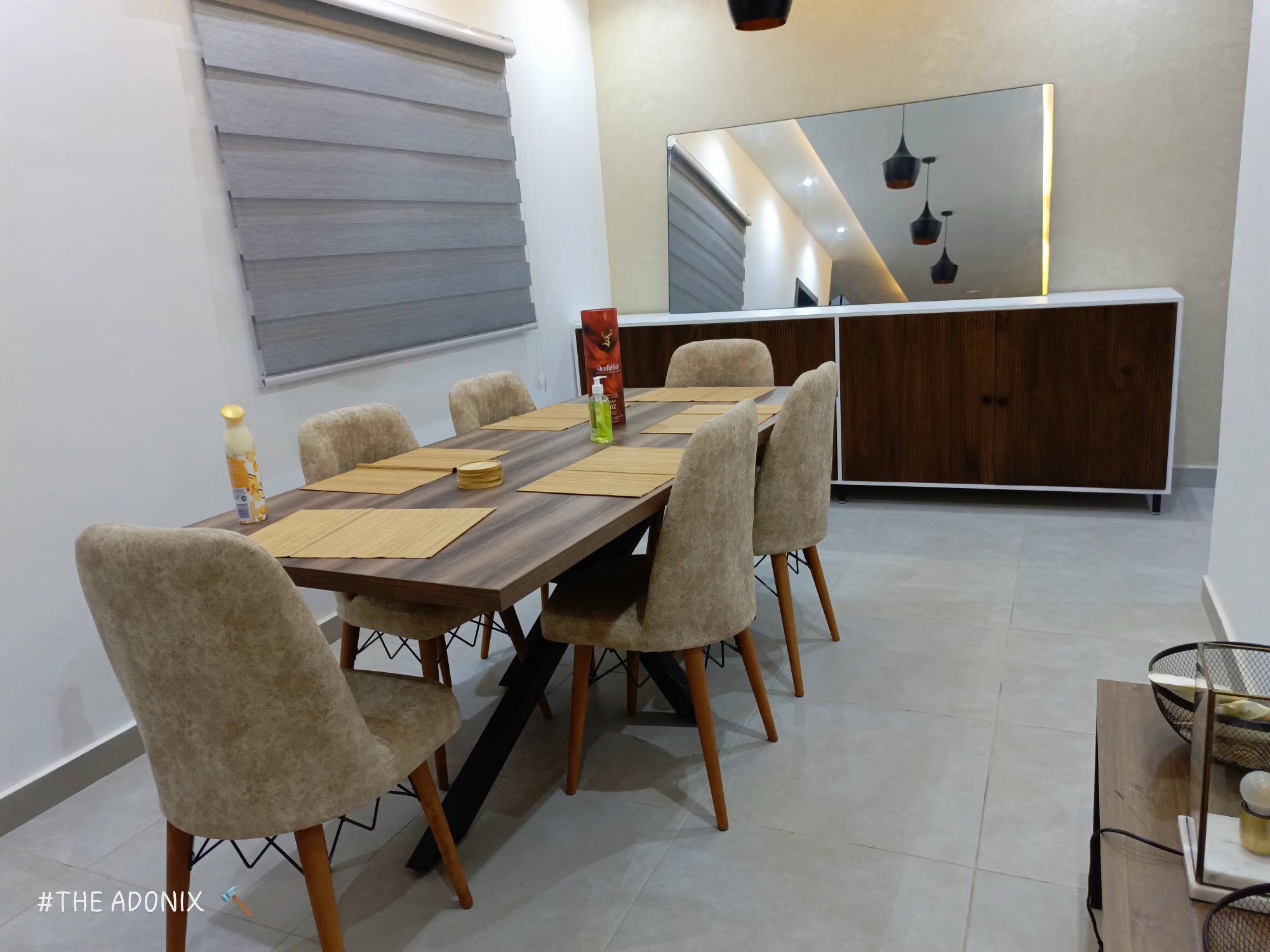 Wood dining table with upholstered chairs and matching sideboard