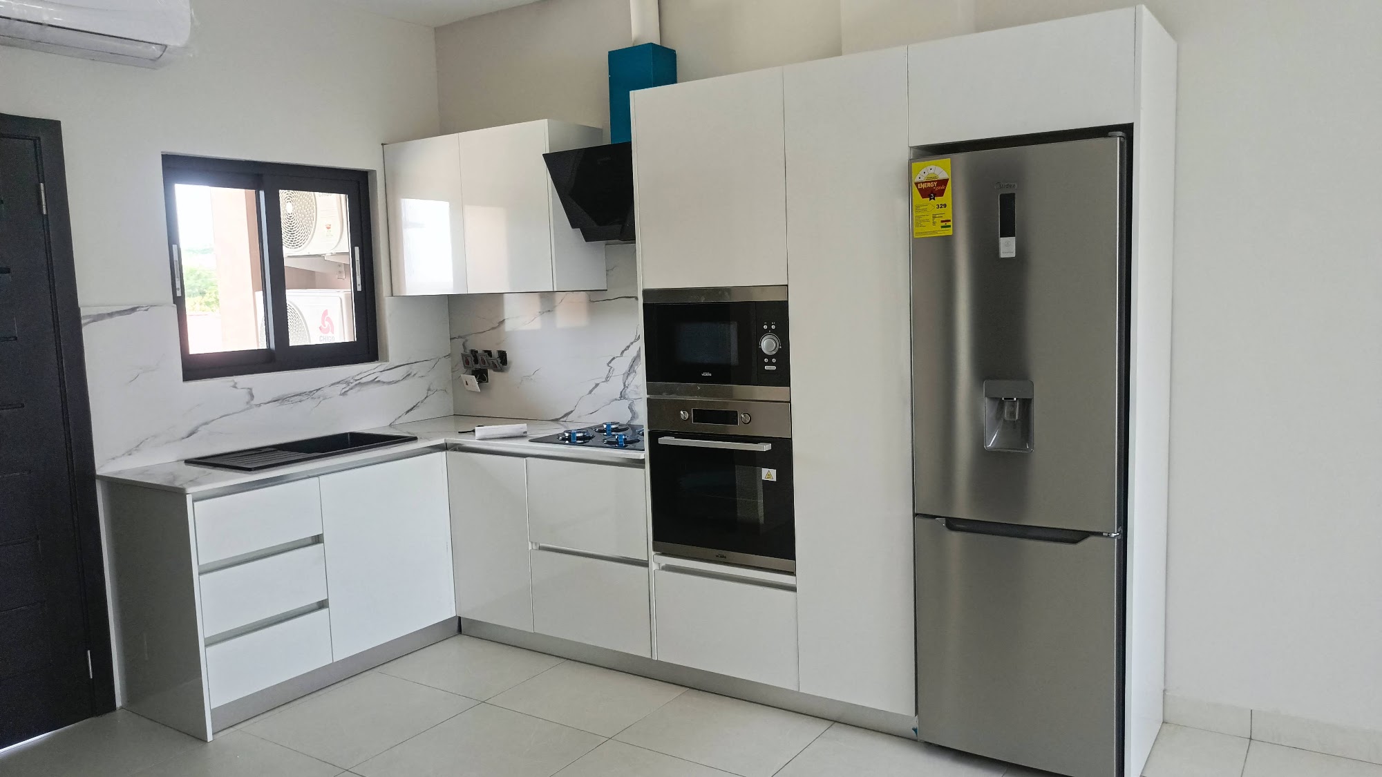 White fitted kitchen cabinetry with built-in appliances